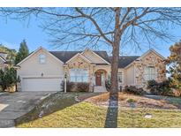 Attractive one-story home with stone accents and a large tree in the front yard at 500 Sierra Vista Way, Raleigh, NC 27615