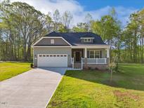 Charming single-Gathering home boasts a welcoming front porch and a well-manicured lawn at 5394 Salem Woods Dr # 16, Graham, NC 27253