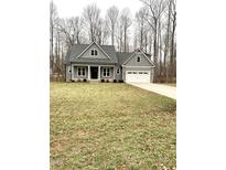 Charming single-story home with gray siding, white trim, and well-manicured front lawn at 55 Running Deer Path, Timberlake, NC 27583