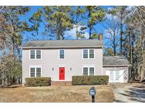 Two-story house with gray siding, red front door, and attached garage at 8 Harrigan Ct, Durham, NC 27705