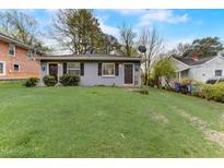 Gray duplex home with two separate entrances and well-maintained lawns at 830 E Lenoir St, Raleigh, NC 27601