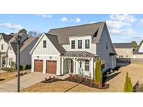 Charming two-story home with a two-car garage and a welcoming covered front porch at 1700 Fordyce Ct, Raleigh, NC 27615