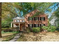 Brick home with mature trees and landscaped yard at 23 Shepherd St, Raleigh, NC 27607