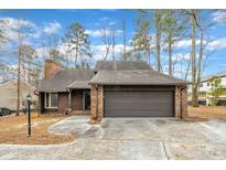 Brick ranch home with attached garage and mature trees at 4209 Pleasant Grove Church Rd, Raleigh, NC 27613