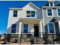 Charming two-story home with black fence and stone foundation, offering curb appeal at 500 Traditions Grande Blvd # 22, Wake Forest, NC 27587