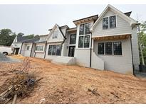 Newly constructed home features a gray painted brick exterior, black framed windows, and modern architectural design at 7013 Buckhead Dr, Raleigh, NC 27615