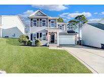 Two-story house with gray siding, stone accents, and a well-maintained lawn at 85 Boston Hbr, Cameron, NC 28326