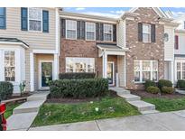 Brick front exterior of charming townhome with landscaping at 891 Cupola Dr, Raleigh, NC 27603