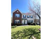 Charming two-story home with brick accents, green shutters, and a well-manicured lawn at 9201 Sayornis Ct, Raleigh, NC 27615
