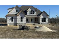 New home under construction featuring a brick facade, gabled roof, and visible framing, awaiting final touches at 11204 Old Beulah Rd, Kenly, NC 27542