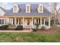 All-brick home with a front porch and landscaped lawn at 114 Legault Dr, Cary, NC 27513