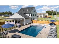 Luxury home with inviting pool, patio, and spacious backyard at 1302 Reading Ct, Burlington, NC 27217