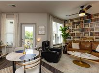 Inviting living room featuring a stylish bookcase wall and modern furnishings at 2313 Gathering Square Ct # 2313, Fuquay Varina, NC 27526