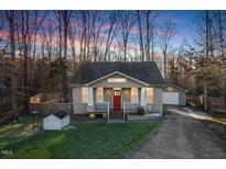 Charming craftsman style home with a red door and attached garage at 3 Moss Spring Ct, Durham, NC 27712