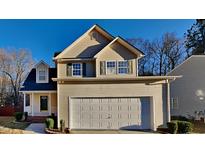 Two-story house with beige vinyl siding, a white garage door, and landscaping at 3905 Grandover Dr, Raleigh, NC 27610