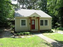 Cute bungalow home with a red door and landscaped yard at 411 Mccauley St, Chapel Hill, NC 27516