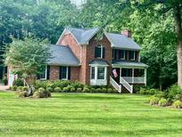 Charming two-story brick home with a landscaped front yard and inviting front porch at 4139 Somerset Dr, Oxford, NC 27565