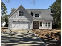 Beautiful exterior of a craftsman home with an attached garage and a concrete driveway at 504 Tucker St, Four Oaks, NC 27524