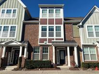 Brick front exterior of charming townhome with multiple windows and landscaping at 549 Balsam Fir Dr Dr, Cary, NC 27519