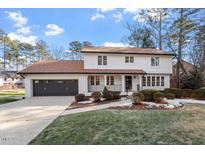 Two-story house with white exterior, brown roof, and landscaping at 7300 Grist Mill Rd, Raleigh, NC 27615
