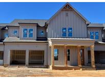 New two-story home with a large front porch, a two-car garage, and gray siding under a clear blue sky at 1031 Coldspring Circle, Durham, NC 27705