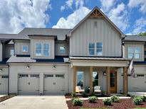 Charming gray two-story home with a two-car garage and inviting front porch at 1031 Coldspring Circle, Durham, NC 27705