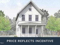 Two-story farmhouse-style home with front porch and landscaping at 1552 Piney Falls Dr, Wendell, NC 27591