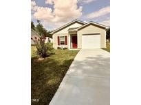 Tan house with red door, single car garage, and landscaped lawn at 159 Bywood Dr, Roxboro, NC 27573