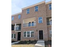 Stunning new construction townhome with a brick exterior and a private balcony at 203 Broomgrove Way, Wake Forest, NC 27587