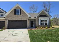 Charming single-Gathering home with a brick facade, well-manicured lawn, and an attached two-car garage at 2094 Harris Farm Ct, Burlington, NC 27215