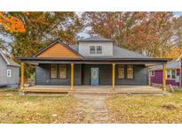 Charming home featuring a covered front porch and a beautifully painted blue front door, perfect for welcoming guests at 210 N Driver St, Durham, NC 27703