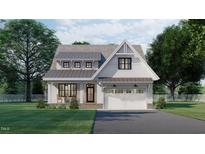 Two-story white house with gray roof, attached garage, and front porch at 2423 Bivins Rd, Durham, NC 27712