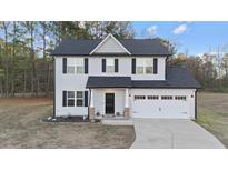 Two-story house with gray siding, black shutters, and a two-car garage at 263 Langdon Chase Way, Selma, NC 27576