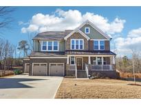 Beautiful two-story home with a three car garage and a brick and siding exterior at 272 W Weatherford Dr, Angier, NC 27501