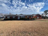 Ranch-style home with brick exterior and spacious lawn at 8110 Nc 210 N, Angier, NC 27501