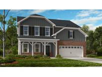 Two-story home with gray siding, brick accents, and a front porch at 101 Cloud Berry Ln, Holly Springs, NC 27540