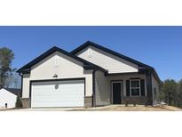 New construction home featuring a white exterior, black trim, two-car garage and brick accent at 11826 Salers Loop, Middlesex, NC 27557