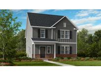 Two-story home with gray siding, brick accents, and landscaping at 1264 Hardin Hill Ln, Knightdale, NC 27545