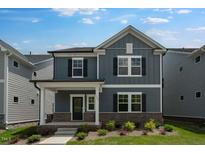 Charming two-story home with a brick foundation, covered porch and a well-manicured lawn at 1264 Hardin Hill Ln, Knightdale, NC 27545