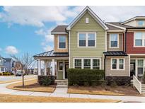 Two-story townhome with light green siding and a covered porch at 1701 Mallard Trace Dr, Wendell, NC 27591