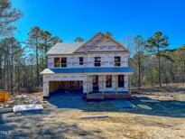 New two-story home under construction with a visible foundation and an attached garage, ready for customization at 346 Duncan Creek Rd # 160, Lillington, NC 27546
