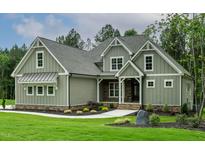 Charming exterior view of a home with gray siding, stone accents, manicured lawn and walkway at 3913 Cedar Knolls # 7, Youngsville, NC 27596