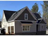 Two-story house with gray siding, stone accents, and a two-car garage at 3923 Cedar Knolls Dr # 12, Youngsville, NC 27596