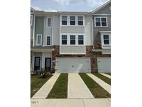 Charming townhome with a two-car garage and beautiful curb appeal at 5302 River Reach Dr, Raleigh, NC 27616