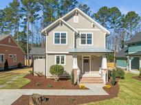 Charming two-story home featuring a landscaped yard, craftsman architecture, and inviting front porch at 713 Heidelberg St, Durham, NC 27704