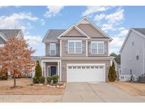 Two-story house with a neutral color scheme and a two-car garage at 1122 Tulip Poplar Rd, Fuquay Varina, NC 27526