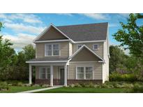 Two-story home with brick and siding, featuring a welcoming front porch at 1228 Hardin Hill Ln, Knightdale, NC 27545