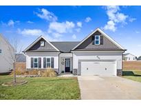 Two-story Craftsman home with gray and white exterior, two-car garage, and landscaping at 142 Jade St, Smithfield, NC 27577