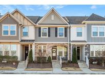 Three-story townhouses with stone accents and front porches at 1609 Mallard Trace Dr, Wendell, NC 27591