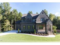 Two-story house with brick and siding, multiple windows, and a landscaped lawn at 289 Gaines Trl, Pittsboro, NC 27312